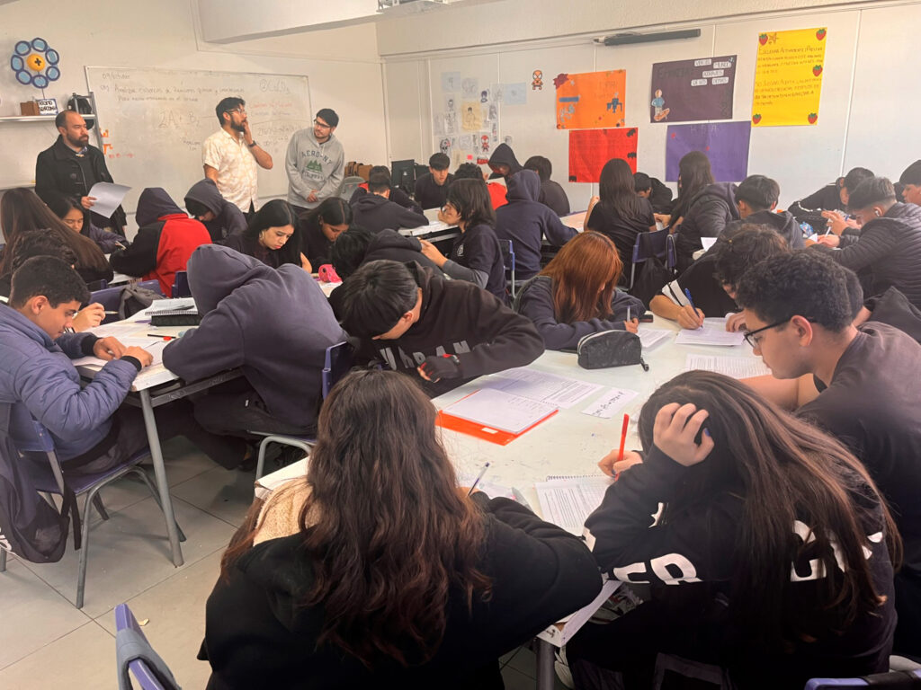 Grupo de estudiantes realizando una actividad en sala de clases.